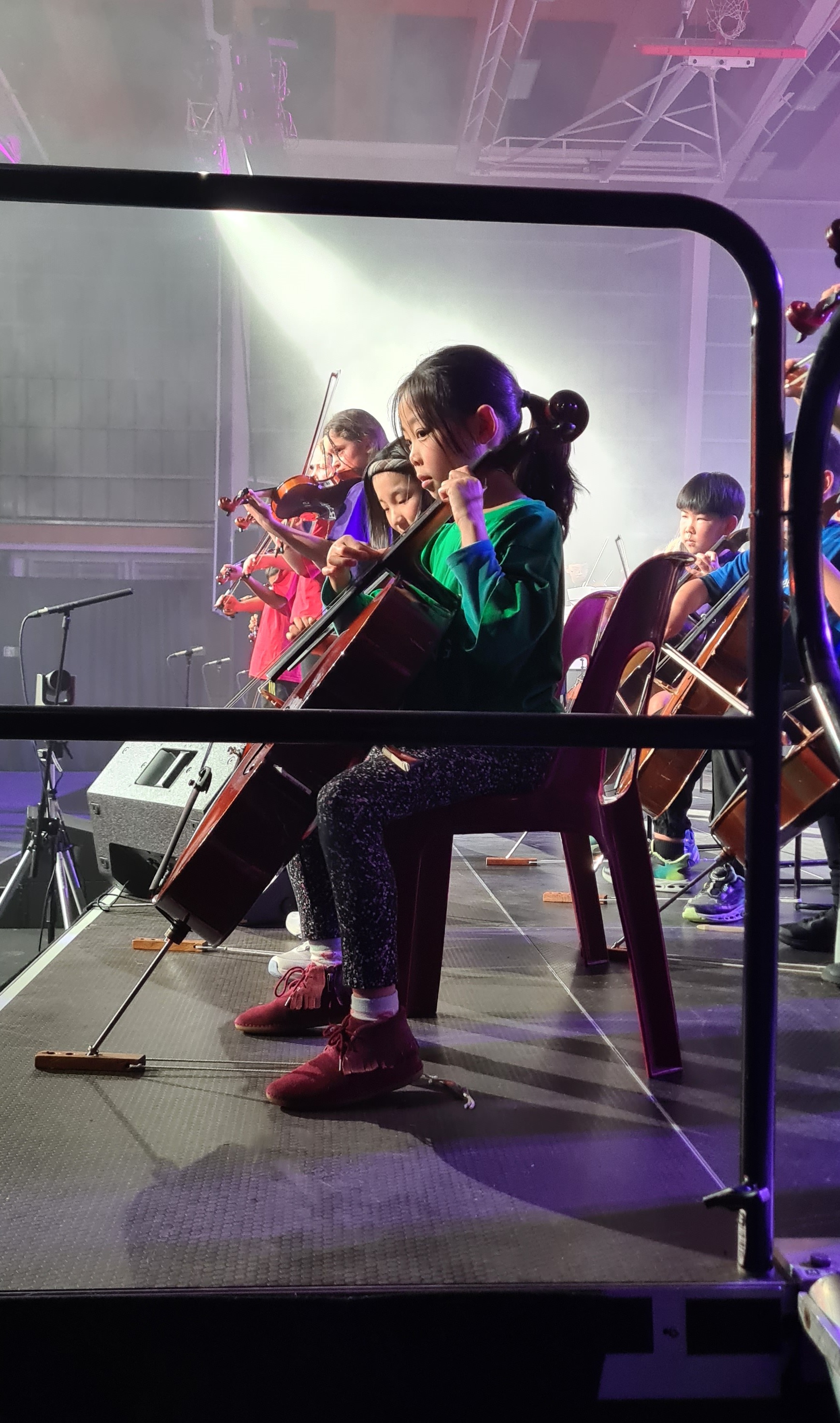 Students playing cellos in rehearsal